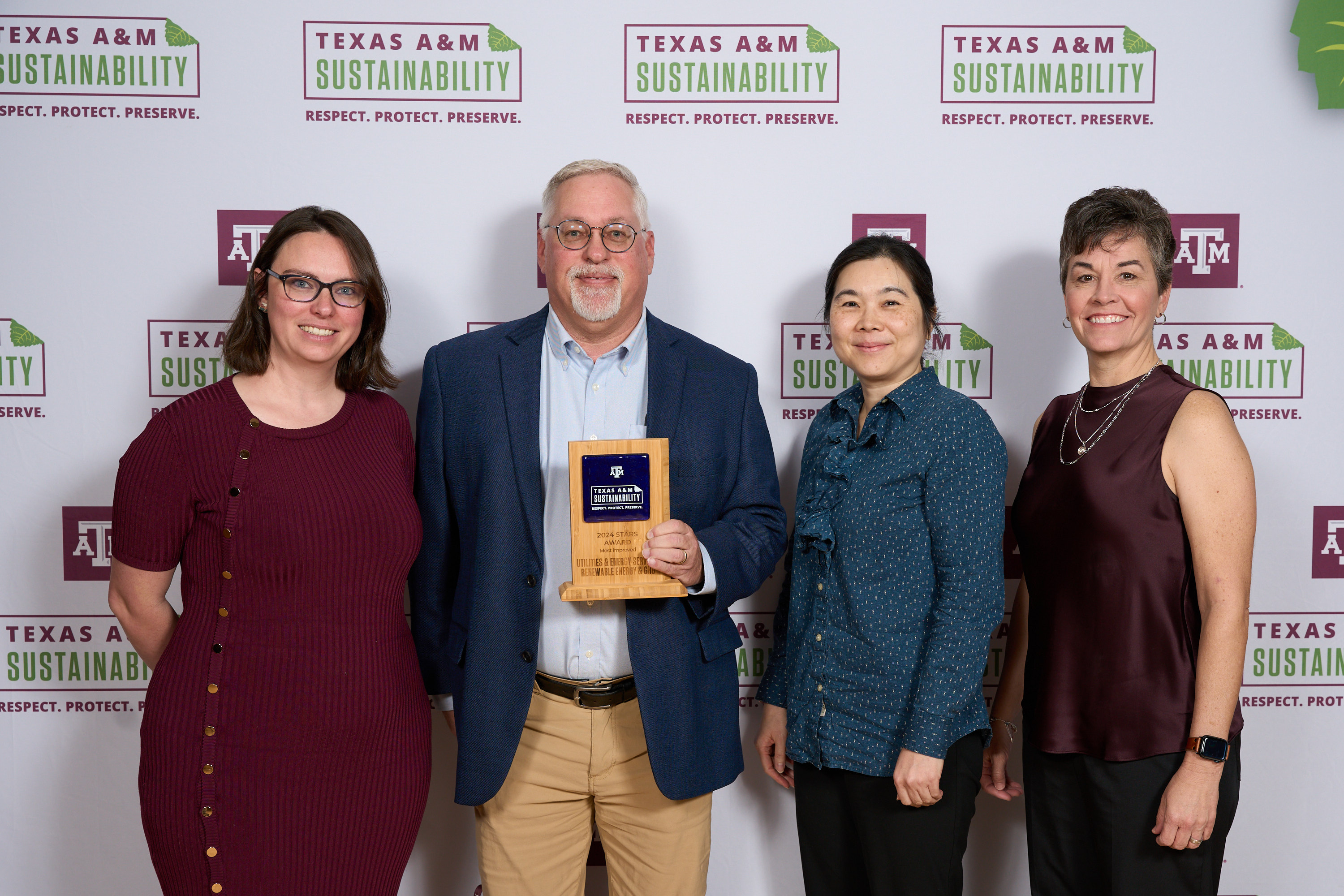 Stuart Hightower and Yasuko Sakurai accepting an award from Kelly Wellman and Danielle Laperriere.